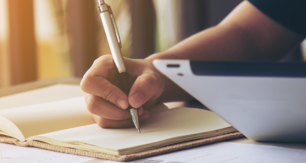 Working remotely in South Africa with tax implications discussed on a tablet and notebook